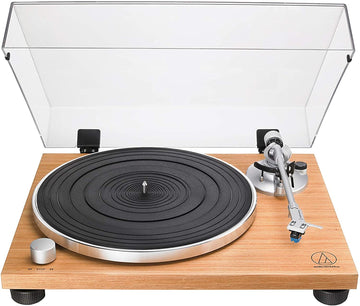 Turntable with wooden base and clear dust cover on a white background.