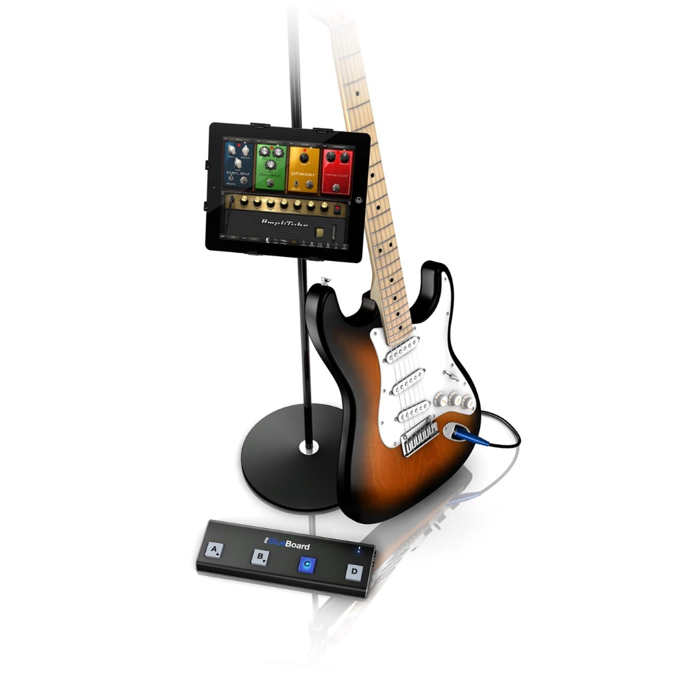 Electric guitar with a tablet and foot pedal on a white background