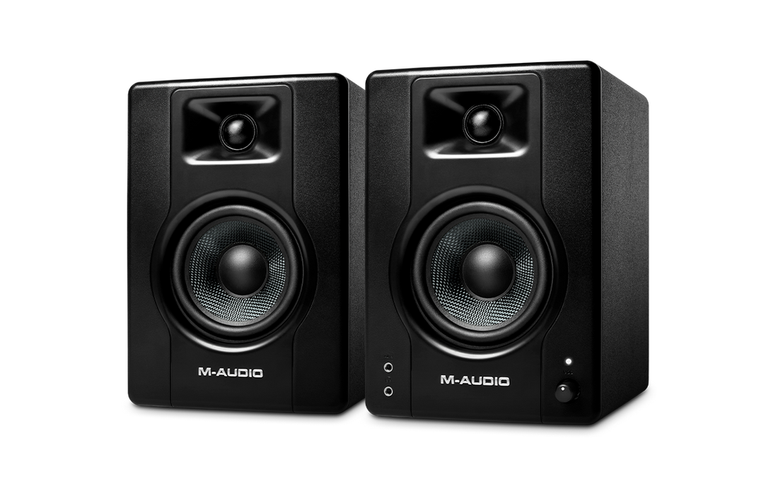Pair of M-Audio studio monitors on a white background