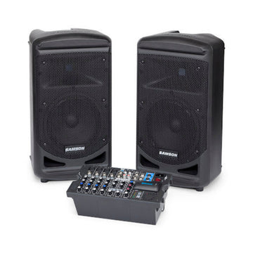 Two black Samson speakers with a mixing console on a white background