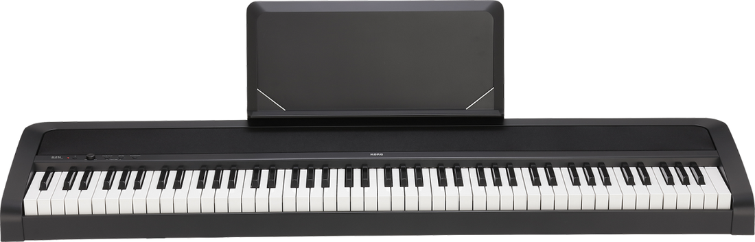 Digital piano with a black amplifier on a white background