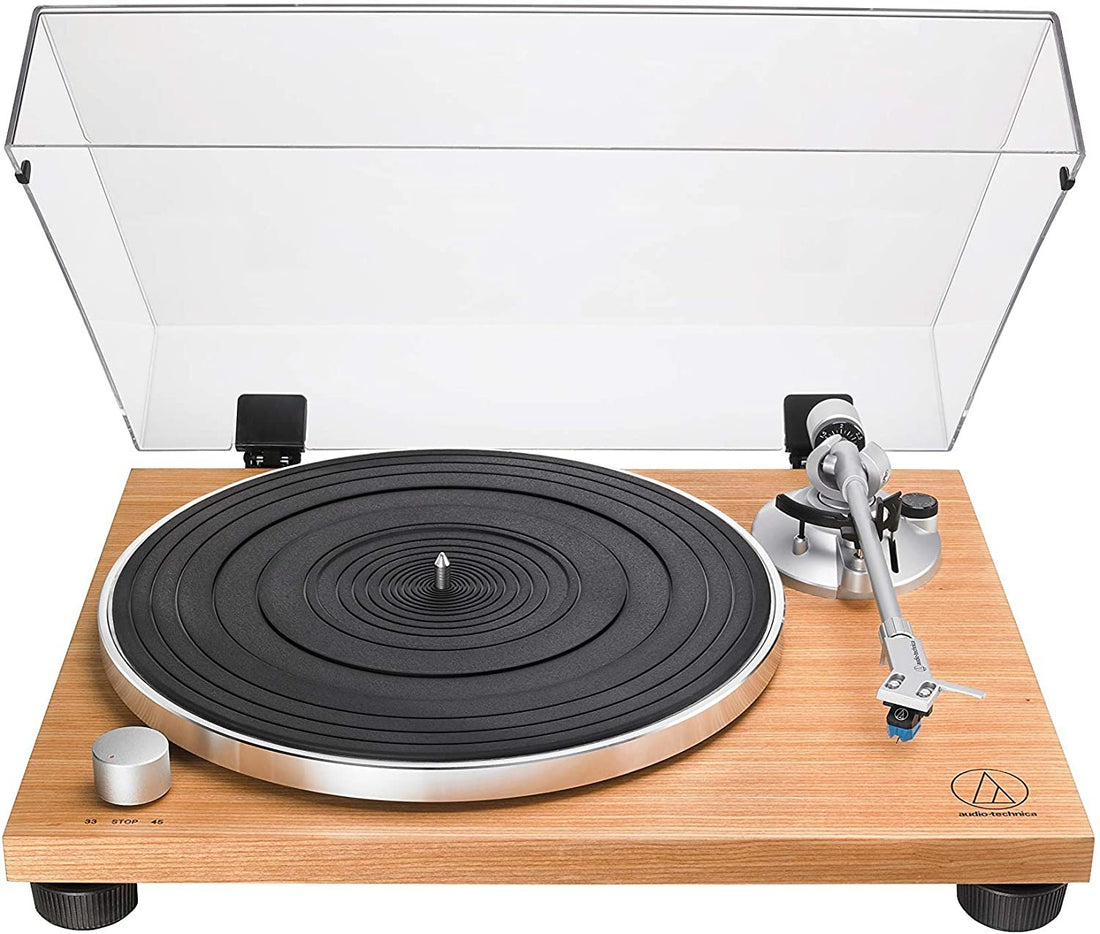 Turntable with wooden base and clear dust cover on a white background.