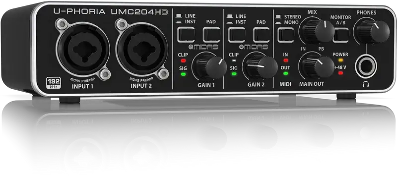 Audio interface with multiple knobs and buttons on a reflective surface