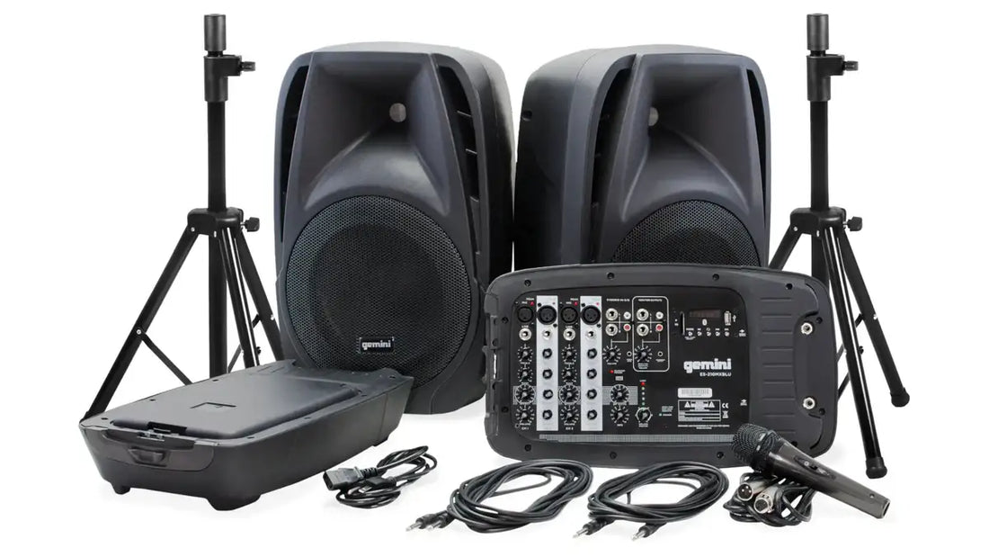 Sound system equipment including speakers, mixer, and stands on a white background