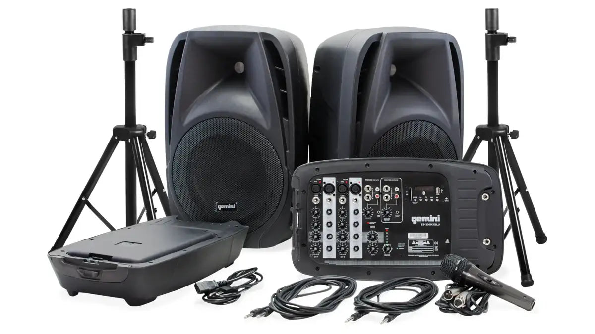 Sound system equipment including speakers, mixer, and stands on a white background