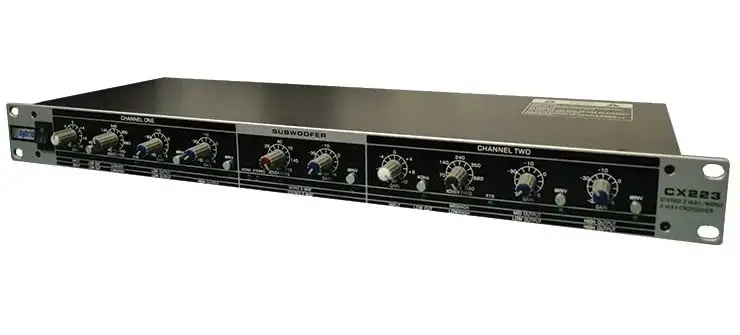 Rack-mounted audio equipment with various knobs and labels on a white background