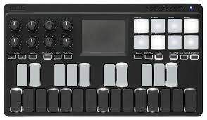 Black electronic music controller with buttons and display on a white background