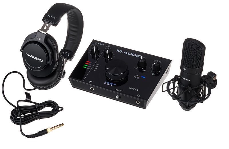 M-Audio audio interface, headphones, and microphone on a white background