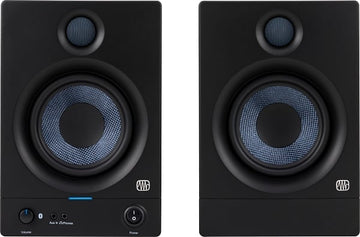 Pair of black studio monitors with blue mesh drivers on a white background