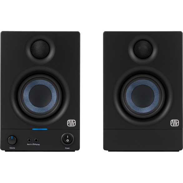 Pair of black audio monitors with visible brand logo on a brown background