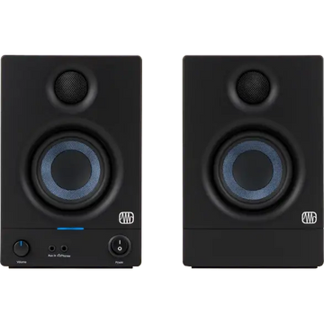 Pair of black audio monitors with visible brand logo on a brown background