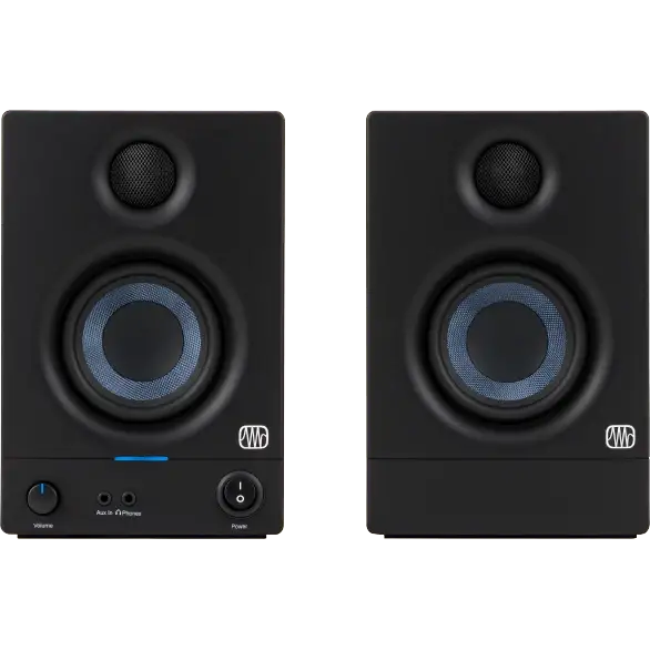 Pair of black audio monitors with visible brand logo on a brown background