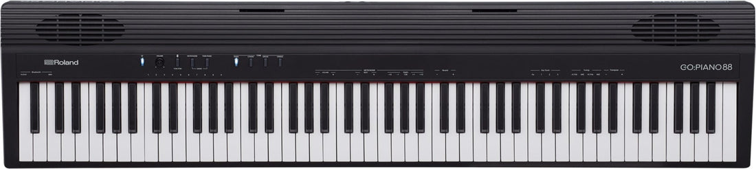 Roland keyboard with black and white keys on a black background