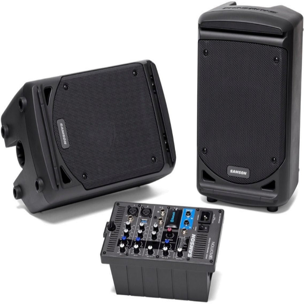 Two black speakers and a audio mixer on a white background
