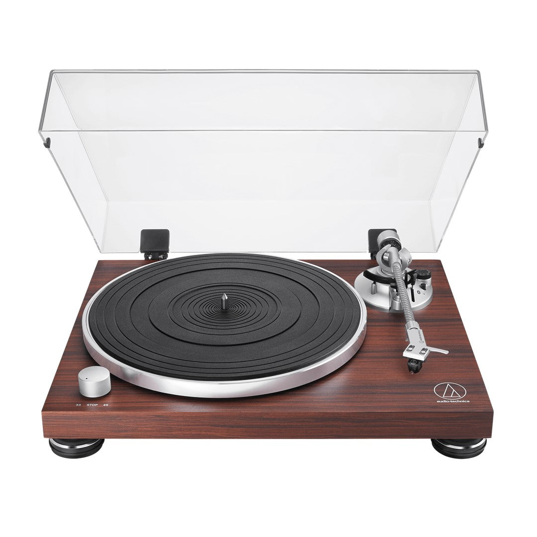 Turntable with wooden base and clear dust cover on a white background